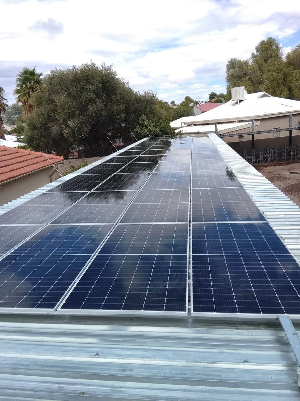 Rail-mounted modules, sheeted roof